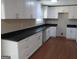 Modern kitchen with white cabinets, dark countertops, and stainless steel hardware at 1967 Levgard Ln, Riverdale, GA 30296