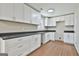Updated kitchen boasts white cabinets with modern hardware and dark countertops at 1967 Levgard Ln, Riverdale, GA 30296