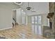 Bright open living area with hardwood floors, a stone fireplace, and modern lighting fixtures at 1967 Levgard Ln, Riverdale, GA 30296