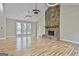 Inviting living room featuring a stone fireplace, hardwood floors, and modern lighting fixtures at 1967 Levgard Ln, Riverdale, GA 30296
