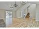 Spacious living room with wood flooring, stone fireplace, modern lighting, and sliding doors to a deck at 1967 Levgard Ln, Riverdale, GA 30296