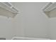 A walk-in closet with white painted shelf and rod at 1967 Levgard Ln, Riverdale, GA 30296