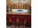 Entertainment wet bar area with barstool seating and custom cabinets at 275 Old Mill Ct, Fayetteville, GA 30214