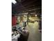 Unfinished basement with exposed ceiling, tool bench, and storage at 275 Old Mill Ct, Fayetteville, GA 30214