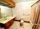 Well-lit bathroom features vanity with double sinks, tile flooring and shower tub combination at 275 Old Mill Ct, Fayetteville, GA 30214