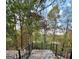 Deck with ornate black railing provides beautiful views of surrounding trees and the lake below at 275 Old Mill Ct, Fayetteville, GA 30214