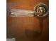 Close-up shot of a vintage glass doorknob with decorative brass accents on a wooden door at 275 Old Mill Ct, Fayetteville, GA 30214