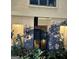 Close-up of home facade with window and statue niches surrounded by landscaping at 275 Old Mill Ct, Fayetteville, GA 30214