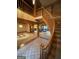 Interior of a foyer with a curved staircase and views into the living room and bar area at 275 Old Mill Ct, Fayetteville, GA 30214