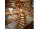 View of the winding staircase leading down to the carpeted basement game room with billiard table at 275 Old Mill Ct, Fayetteville, GA 30214