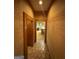 Hallway with a brick tile floor leading to a kitchen with updated appliances at 275 Old Mill Ct, Fayetteville, GA 30214