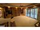 Spacious living room featuring a built-in bookcase, neutral carpet, and sliding glass doors to the porch at 275 Old Mill Ct, Fayetteville, GA 30214