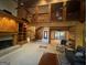 Spacious living room featuring a fireplace, built-in shelving, a spiral staircase and wood detailing throughout at 275 Old Mill Ct, Fayetteville, GA 30214