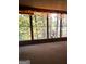 View from the sunroom shows the beautiful surrounding nature, with string lights creating a warm atmosphere at 275 Old Mill Ct, Fayetteville, GA 30214
