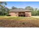 Brick home with a walkout basement and back porch overlooking a large grassy backyard at 830 Streamside Dr, Mcdonough, GA 30252