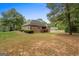 Brick home with walkout basement and back porch overlooking a large green backyard at 830 Streamside Dr, Mcdonough, GA 30252