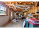 Unfinished basement with exposed insulation in the ceiling, concrete floor, and shelving at 830 Streamside Dr, Mcdonough, GA 30252