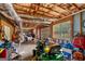 Unfinished basement with exposed ceiling, concrete floor, garage door, and window at 830 Streamside Dr, Mcdonough, GA 30252