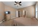 Carpeted bedroom featuring a ceiling fan and a dresser with a TV on top at 830 Streamside Dr, Mcdonough, GA 30252