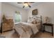 Cozy bedroom with a metal bed frame, neutral decor, and a window providing natural light at 830 Streamside Dr, Mcdonough, GA 30252