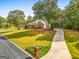 Beautiful brick home with a long driveway, landscaped yard, and mature trees at 830 Streamside Dr, Mcdonough, GA 30252