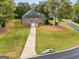 Brick home with an attached garage and a long driveway, complemented by a lush green lawn and mature trees at 830 Streamside Dr, Mcdonough, GA 30252