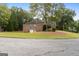 Brick home with an attached garage and well-maintained lawn on a quiet street at 830 Streamside Dr, Mcdonough, GA 30252