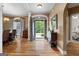 Inviting foyer with hardwood floors, decorative lighting, and a view of the dining room at 830 Streamside Dr, Mcdonough, GA 30252