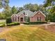 Stately brick home with meticulously maintained landscaping, mature trees, and an inviting facade at 830 Streamside Dr, Mcdonough, GA 30252