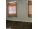 An interior view of a room with dark hardwood flooring and curtains on the window at 953 South Ave, Forest Park, GA 30297