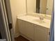 Well-lit bathroom featuring a vanity with a sink, a mirror, and storage space, with hardwood floors at 1272 Creekside Se Ter, Smyrna, GA 30082