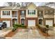 Charming townhomes with brick and siding exteriors, well-manicured lawns, and private driveways at 2786 Snapfinger Mnr, Decatur, GA 30035