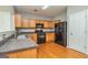 Traditional kitchen features oak cabinets, black appliances, and hardwood floors at 2786 Snapfinger Mnr, Decatur, GA 30035