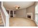 Open-plan living room with fireplace, arched entryway, and staircase at 2786 Snapfinger Mnr, Decatur, GA 30035