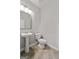 Simple half bathroom features a pedestal sink, tiled floor, and white toilet at 5915 Langdale Chase # 16, Douglasville, GA 30135