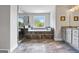 This bathroom features a luxurious soaking tub, granite countertops, and a separate shower with elegant tile at 5915 Langdale Chase # 16, Douglasville, GA 30135