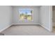 Bright bedroom features a carpeted floor and a window with a view of the neighborhood at 5915 Langdale Chase # 16, Douglasville, GA 30135