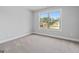 Bright bedroom features a carpeted floor and a window with a view of the neighborhood at 5915 Langdale Chase # 16, Douglasville, GA 30135