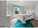 Stylized bedroom with carpeted floor features white furniture and colorful bedding at 5915 Langdale Chase # 16, Douglasville, GA 30135