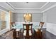 Modern dining room with hardwood floors, crown molding, and stylish lighting at 5915 Langdale Chase # 16, Douglasville, GA 30135