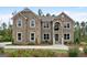 Beautiful two-story brick home with a landscaped front yard and blooming flower beds at 5915 Langdale Chase # 16, Douglasville, GA 30135