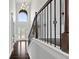 Elegant foyer features high ceilings, dark hardwood floors, and a staircase with iron railings at 5915 Langdale Chase # 16, Douglasville, GA 30135