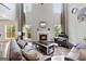 Bright living room featuring a fireplace, high ceilings, and plush seating area with multiple windows at 5915 Langdale Chase # 16, Douglasville, GA 30135