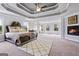 This main bedroom features a fireplace, tray ceiling, and plush carpet, creating a luxurious retreat at 5915 Langdale Chase # 16, Douglasville, GA 30135