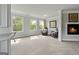 Sitting area features a cozy fireplace and plush carpet, creating a relaxing space with scenic outdoor views at 5915 Langdale Chase # 16, Douglasville, GA 30135