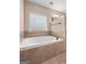 Large white bathtub with tile surround and brushed nickel fixtures at 182 Nobility Ln, Mcdonough, GA 30252