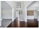 Bright, two-story foyer with hardwood floors, a staircase, and white wainscoting creating an open and airy feel at 5905 Langdale Chase # 17, Douglasville, GA 30135