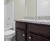 Bathroom features a shower/tub combination with a granite vanity and dark cabinets at 6600 Wansfell Ct # 28, Douglasville, GA 30135