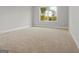 Bright bedroom featuring plush carpeting and a window with a view of the outdoors at 6600 Wansfell Ct # 28, Douglasville, GA 30135