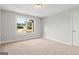 This bedroom has neutral walls, carpet, and natural light at 6600 Wansfell Ct # 28, Douglasville, GA 30135